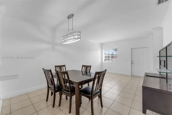 a view of a dining room with furniture and chandelier