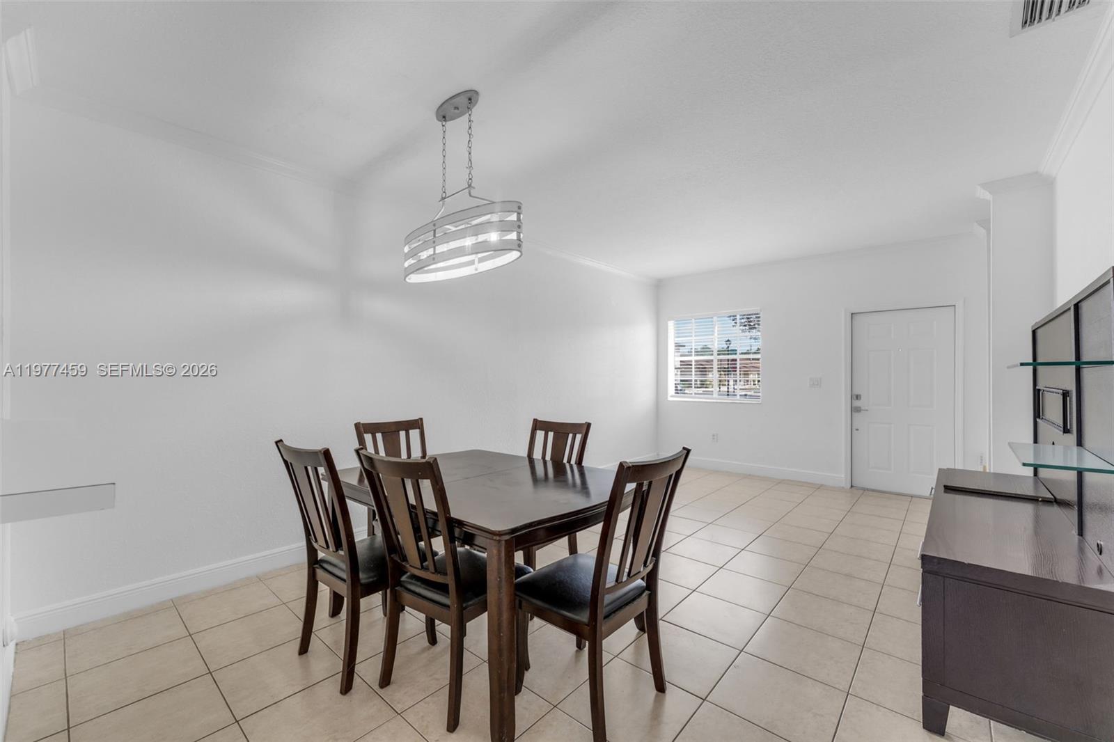 17040 Southwest 137th Place Miami, FL 33177 - Photo 4 of 29 a view of a dining room with furniture and chandelier