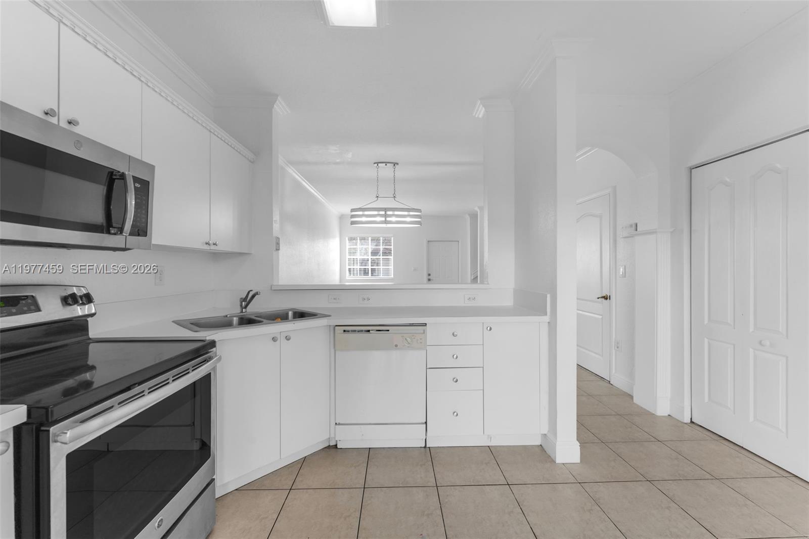 17040 Southwest 137th Place Miami, FL 33177 - Photo 7 of 29 a kitchen with white cabinets stainless steel appliances and sink