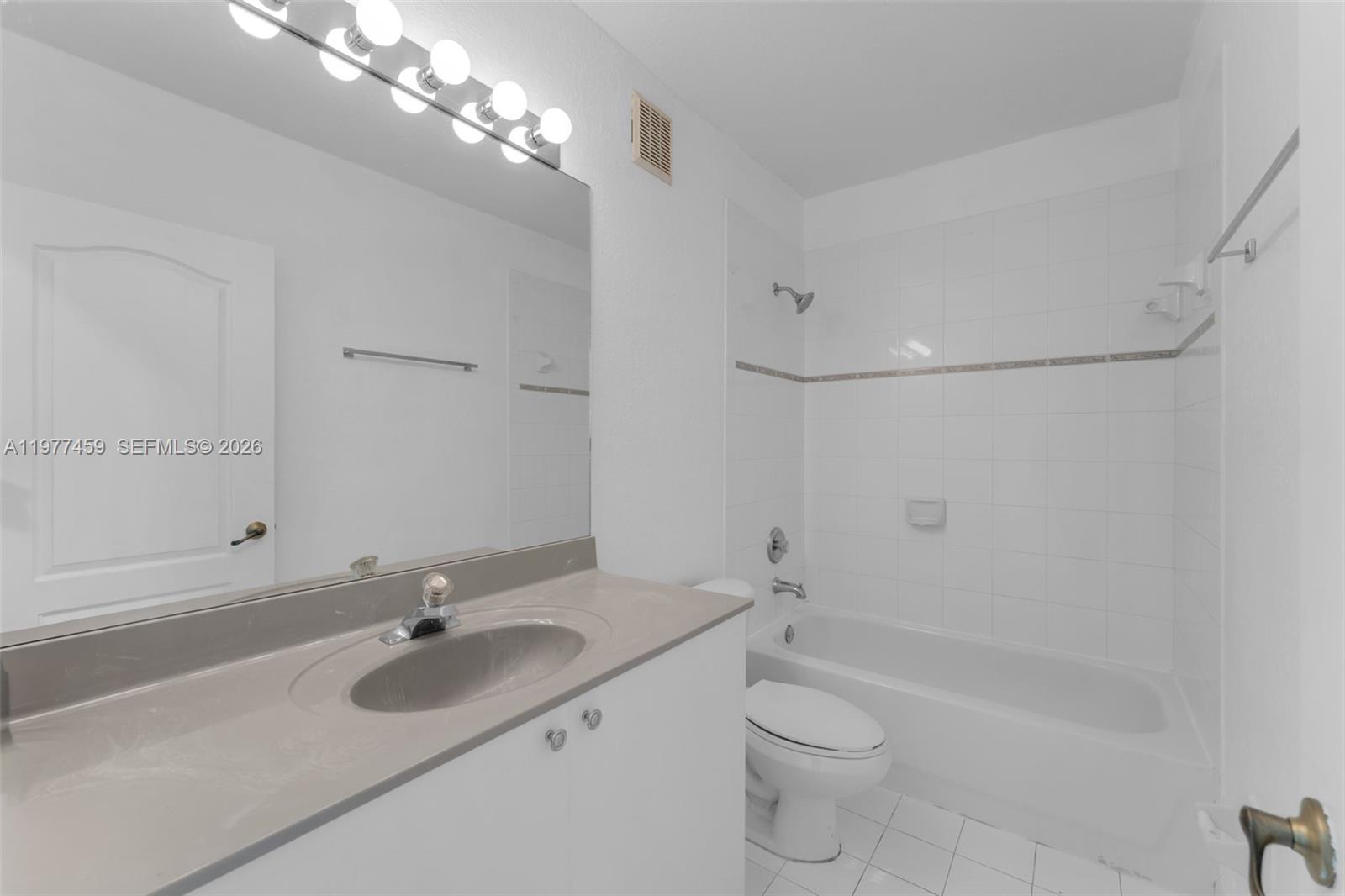 17040 Southwest 137th Place Miami, FL 33177 - Photo 9 of 29 a bathroom with a sink a toilet and shower