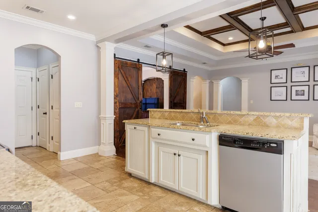 a large kitchen with stainless steel appliances granite countertop a stove and a sink