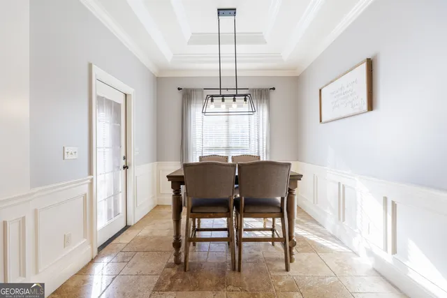 a view of a dining room with furniture and chandelier