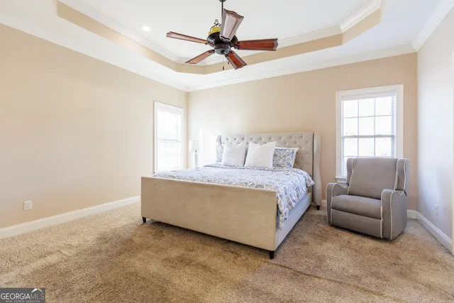 a spacious bathroom with a tub sink and mirror