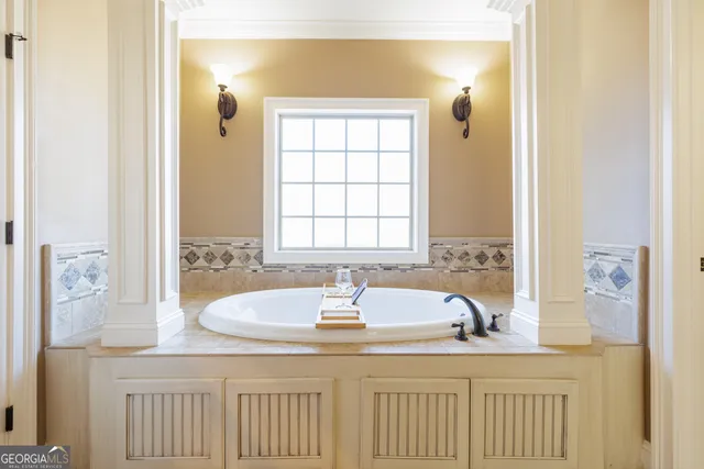 a bathroom with bathtub and window