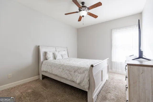 a bedroom with two beds and a flat screen tv