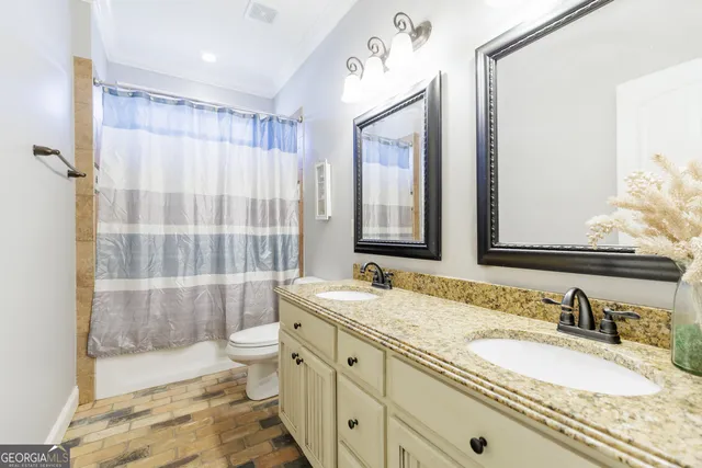 a bathroom with a granite countertop sink mirror and bathtub