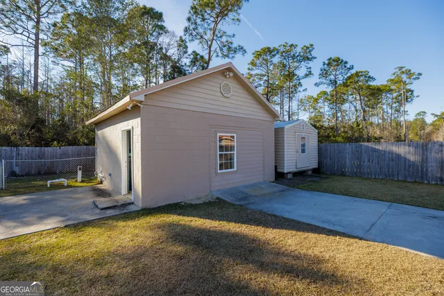 a view of a room with a ceiling fan and entryway