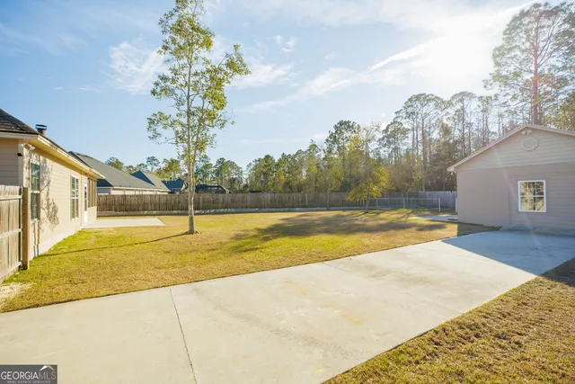 a view of a white house with a yard