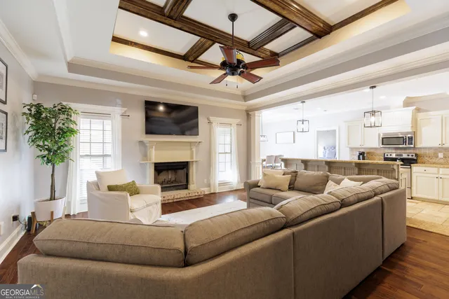 a living room with furniture a flat screen tv and a fireplace