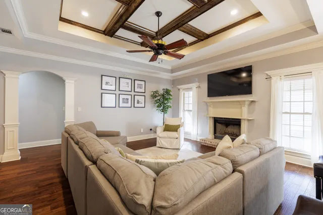 a living room with furniture a fireplace and a flat screen tv