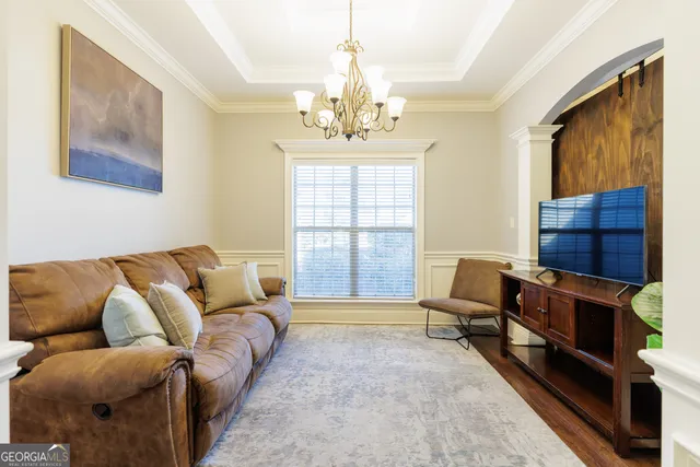 a kitchen with stainless steel appliances granite countertop a refrigerator a sink dishwasher a stove and white cabinets with wooden floor