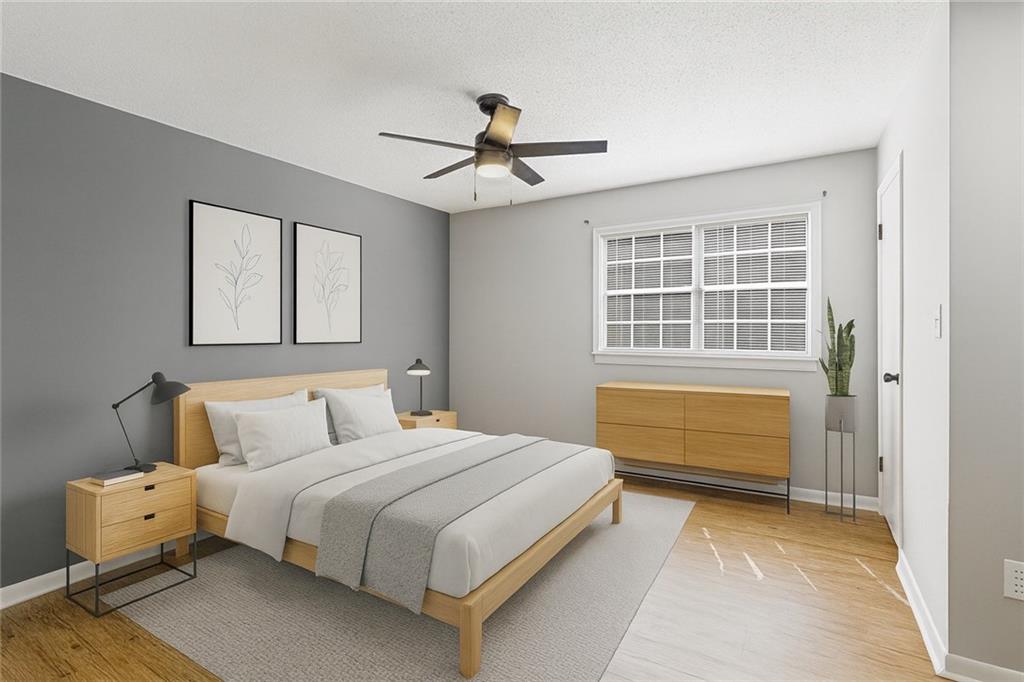 1225 Church Street, Unit J Decatur, GA 30030 - Photo 12 of 27 a bedroom with a bed and a chandelier