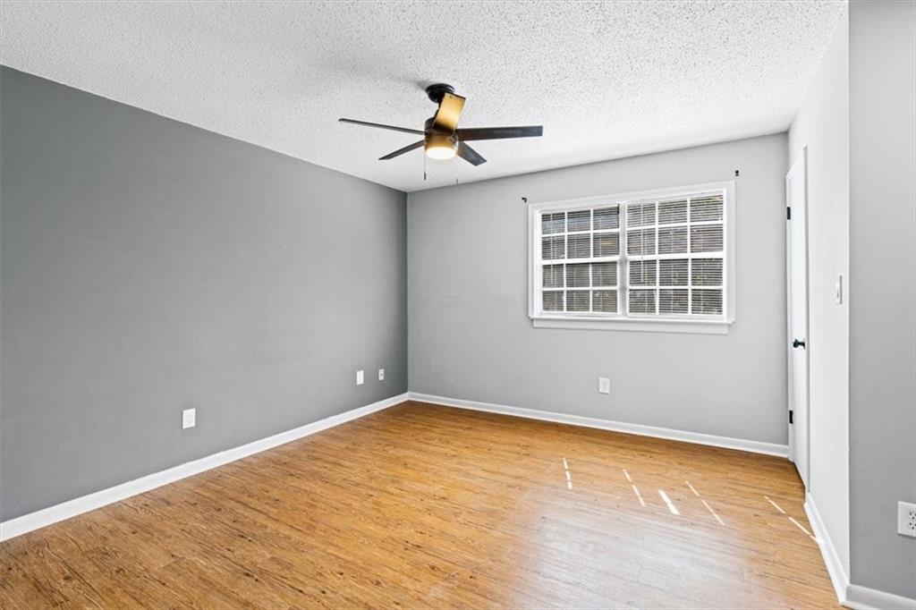 1225 Church Street, Unit J Decatur, GA 30030 - Photo 13 of 27 a view of empty room with wooden floor and ceiling fan