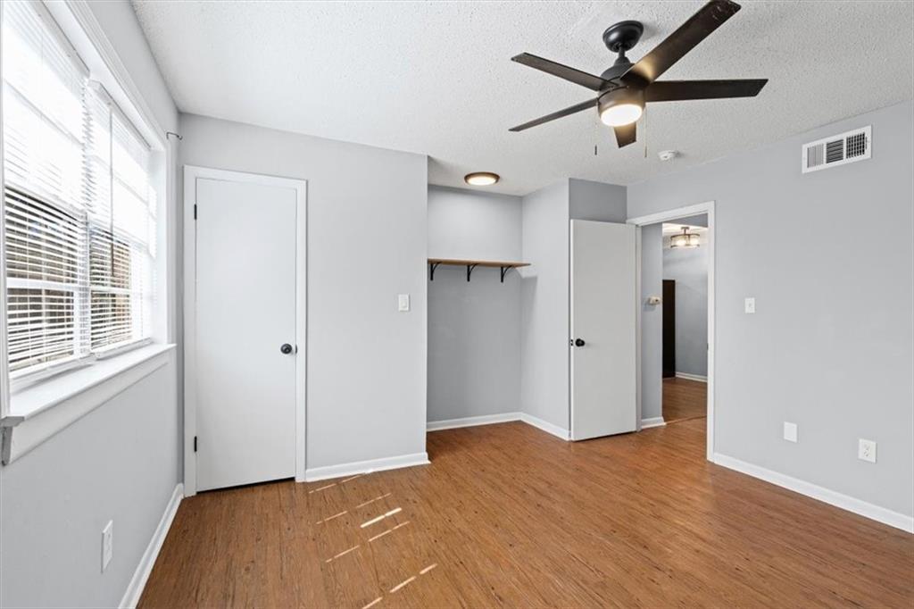 1225 Church Street, Unit J Decatur, GA 30030 - Photo 15 of 27 a view of a big room with wooden floor and a ceiling fan