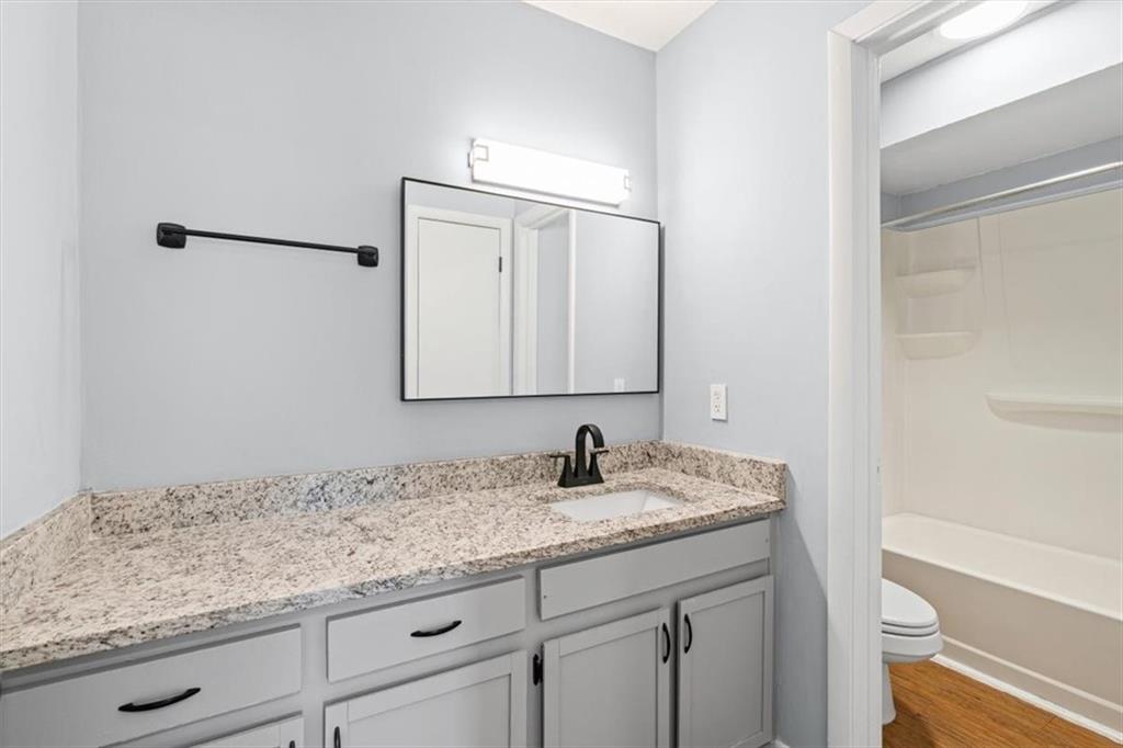 1225 Church Street, Unit J Decatur, GA 30030 - Photo 16 of 27 a bathroom with a granite countertop sink and a mirror