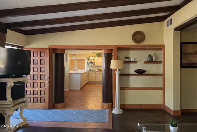a view of a livingroom with wooden floor and a flat screen tv