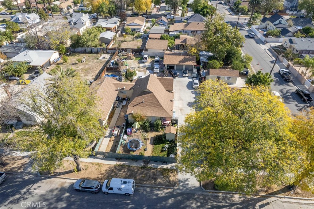 an aerial view of a house with a yard basket ball court and outdoor seating