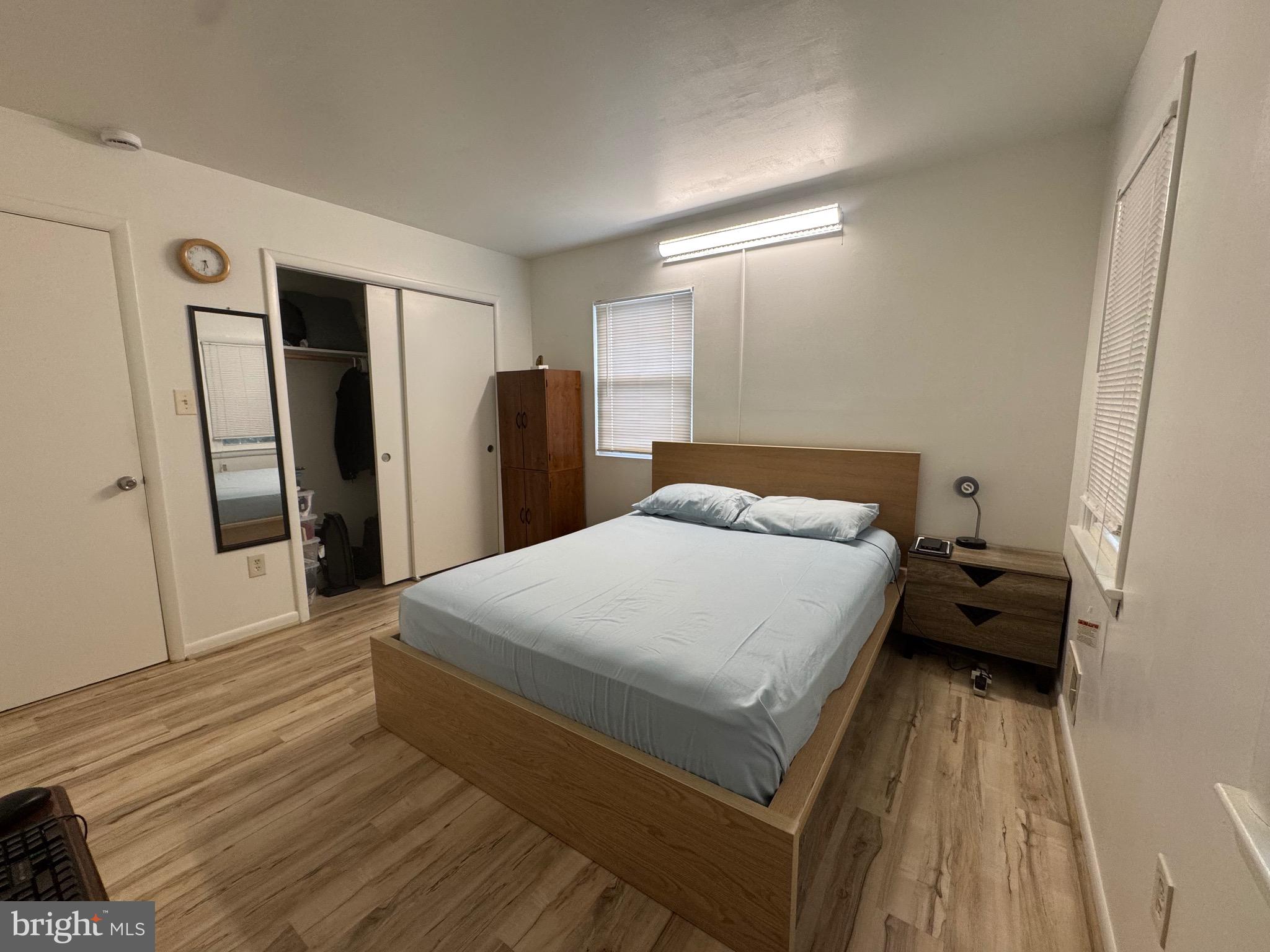 212 11th Street Laurel, MD 20707 - Photo 13 of 39 a bed room with a bed and a refrigerator