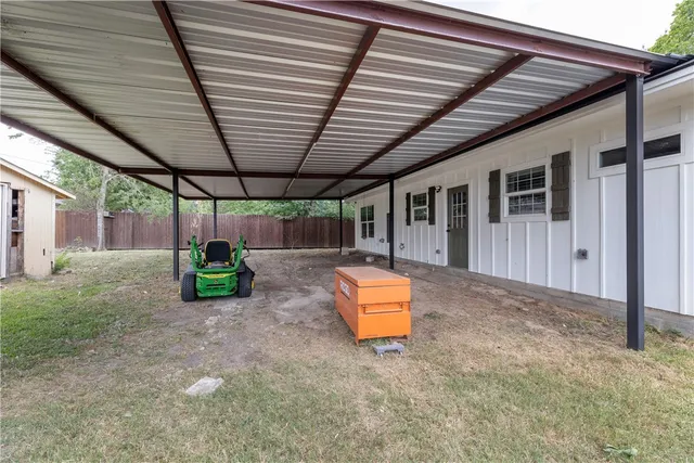 a backyard of a house with table and chairs