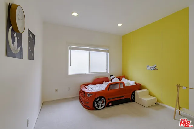 a kitchen with white cabinets a sink a window and appliances