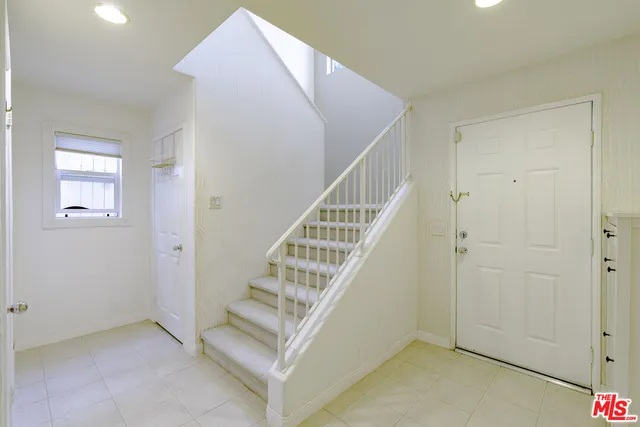 a view of entryway and hall with a workspace