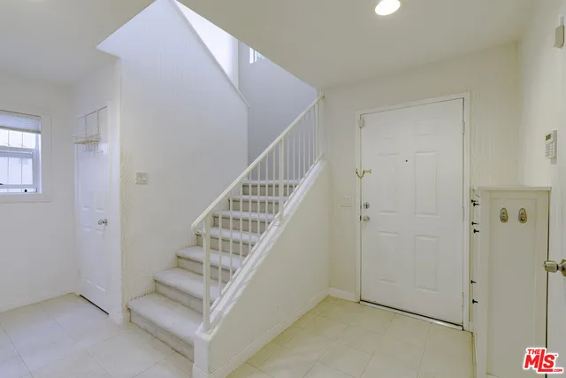 a view of a dining room with furniture and a chandelier