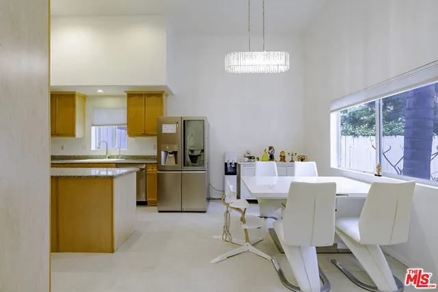 a kitchen that has a lot of cabinets and refrigerator