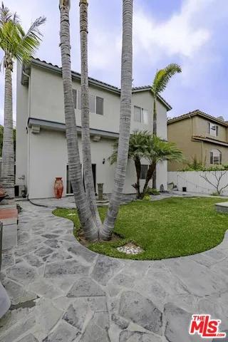 a view of a house with a yard and sitting area