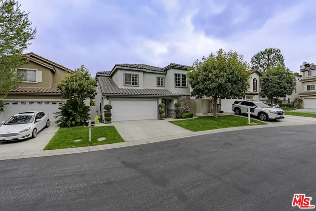a aerial view of a house with plants and large trees