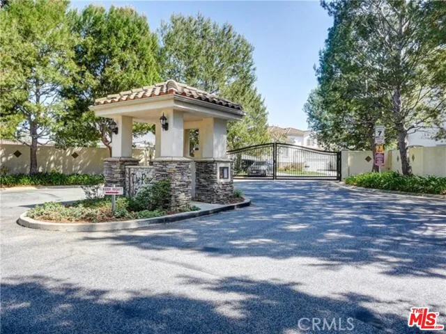 a view of a house with a tree in the background