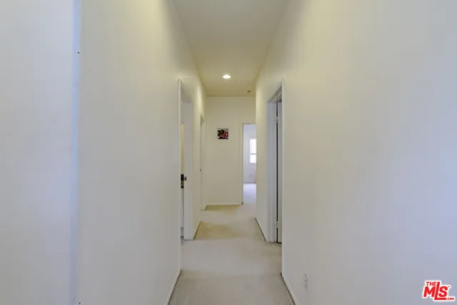 a bathroom with a granite countertop double vanity sink a mirror and a shower