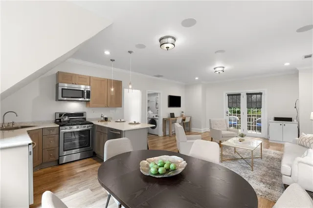 a large kitchen with a table chairs stove and kitchen island