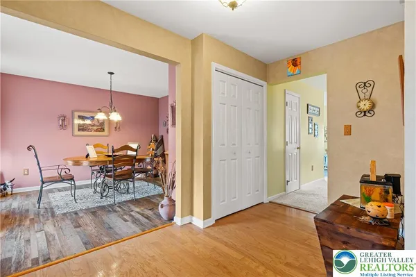 a bedroom with a bed and a dresser with rug