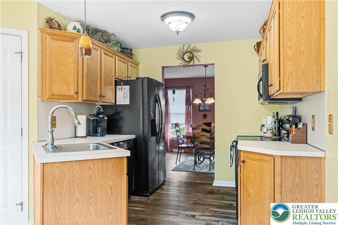 2652 Thistle Road Lower Macungie Township, PA 18062 - Photo 19 of 66 a kitchen with stainless steel appliances kitchen island granite countertop a refrigerator a stove top oven a sink and dishwasher