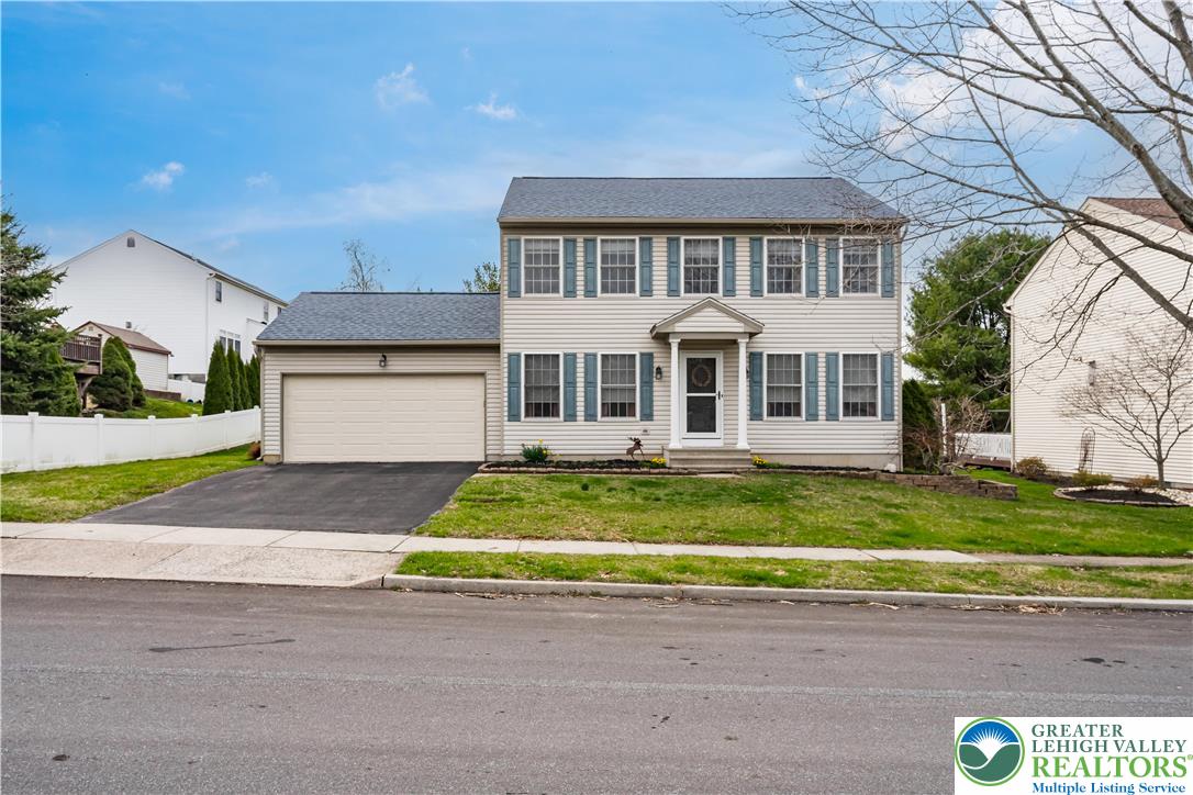 2652 Thistle Road Lower Macungie Township, PA 18062 - Photo 2 of 66 a front view of a house with a yard and garage