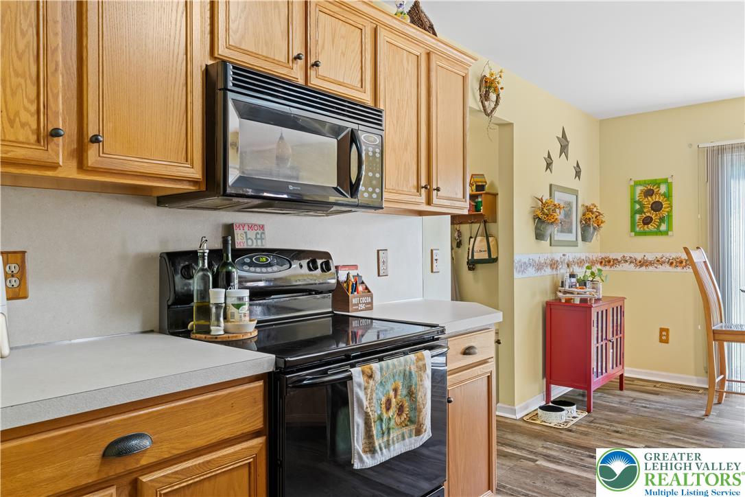 2652 Thistle Road Lower Macungie Township, PA 18062 - Photo 21 of 66 a kitchen with stainless steel appliances granite countertop a stove and a microwave
