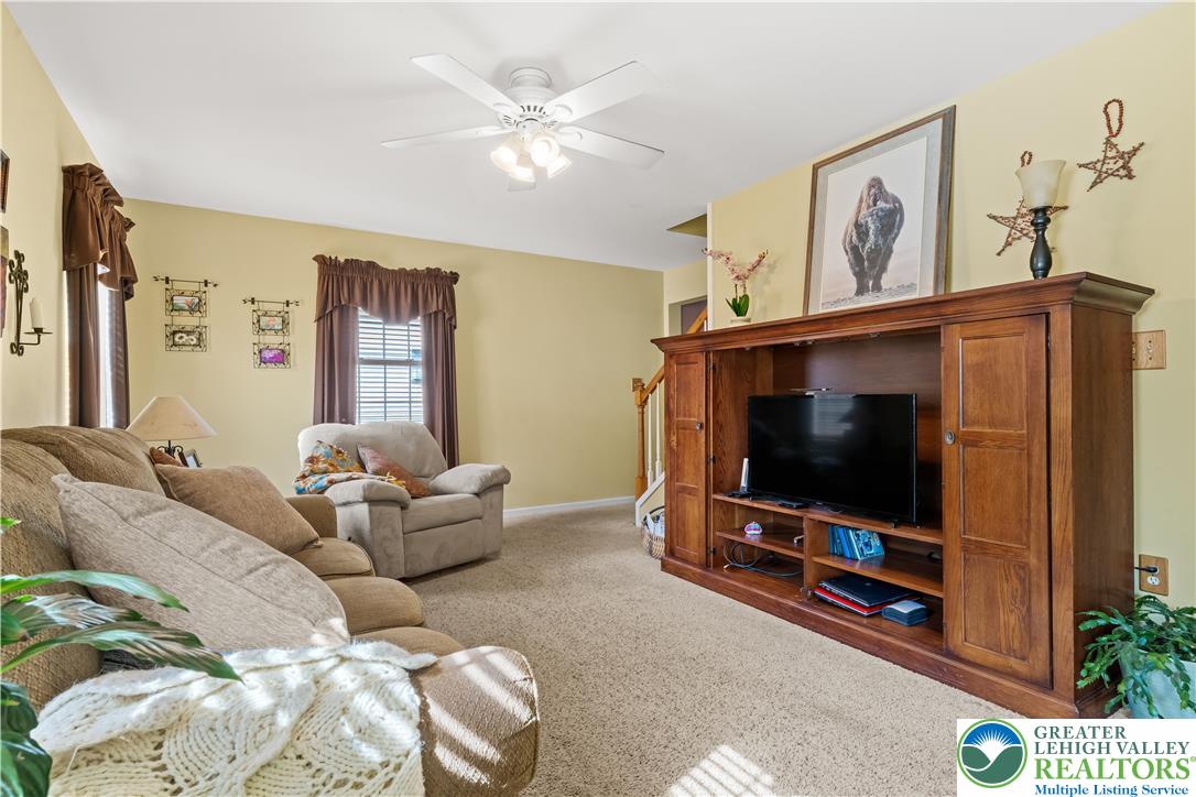 2652 Thistle Road Lower Macungie Township, PA 18062 - Photo 26 of 66 a living room with furniture and a flat screen tv