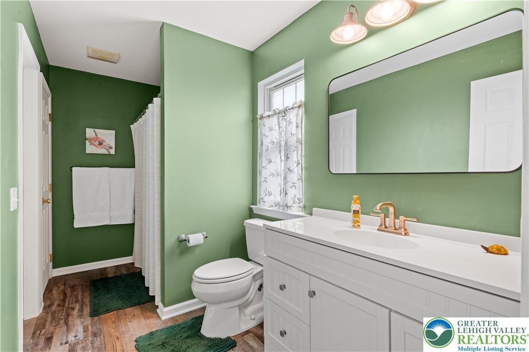 2652 Thistle Road Lower Macungie Township, PA 18062 - Photo 36 of 66 a bathroom with a toilet sink and mirror