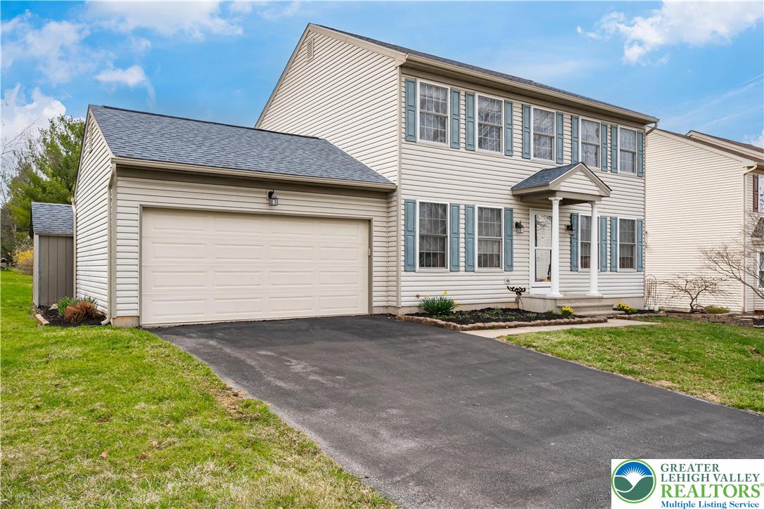 2652 Thistle Road Lower Macungie Township, PA 18062 - Photo 4 of 66 a front view of a house with a yard