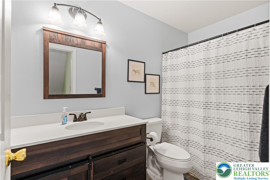 2652 Thistle Road Lower Macungie Township, PA 18062 - Photo 41 of 66 a bathroom with a toilet a sink a mirror and a shower