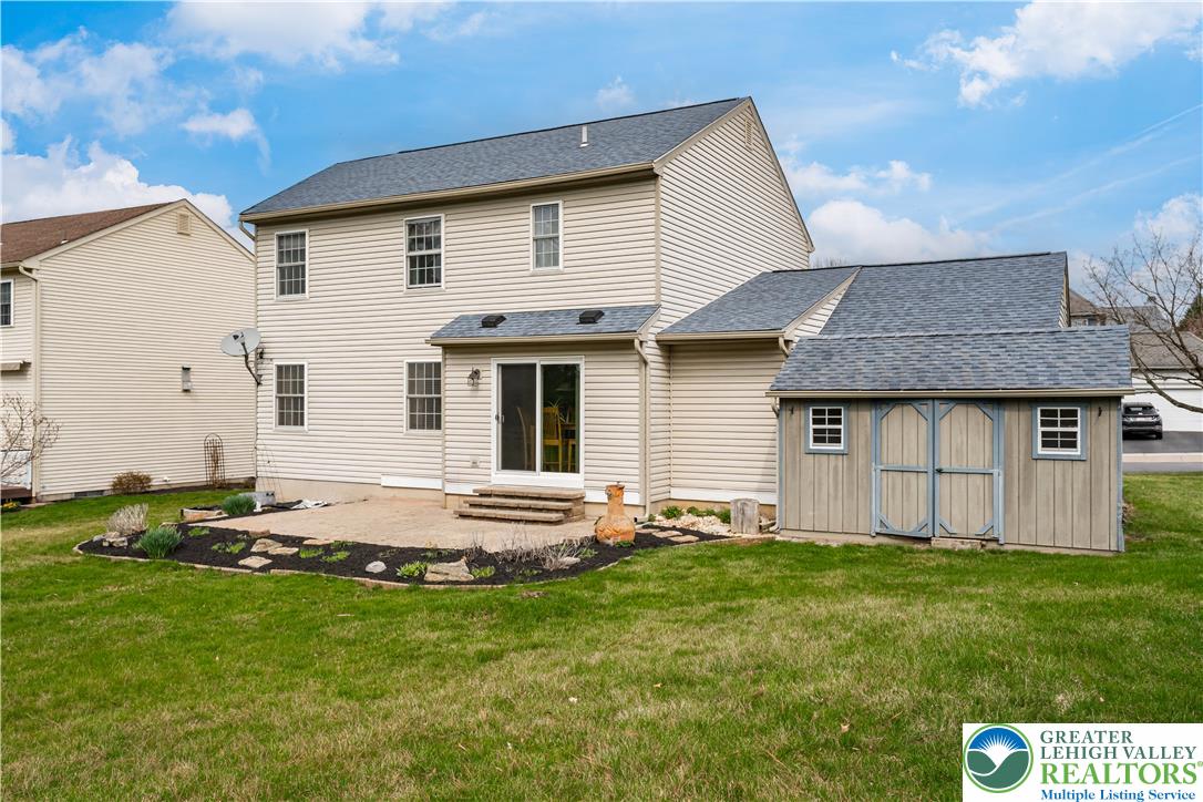 2652 Thistle Road Lower Macungie Township, PA 18062 - Photo 57 of 66 a backyard of a house with table and chairs