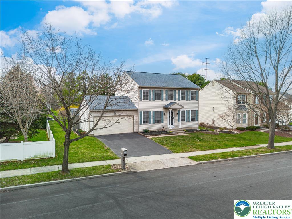 2652 Thistle Road Lower Macungie Township, PA 18062 - Photo 6 of 66 a front view of a house with a yard and garage