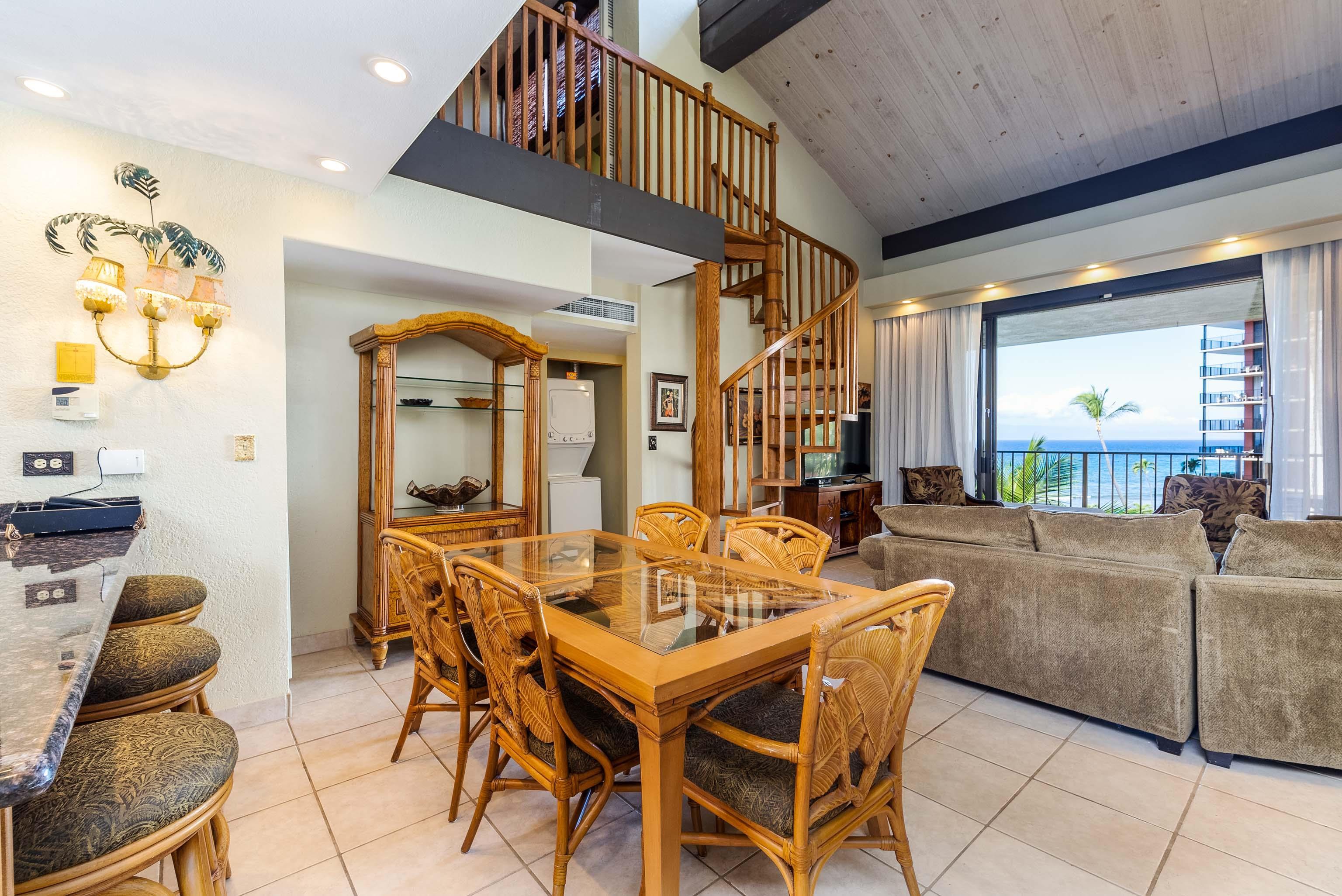 3445 Lower Honoapiilani Road, Unit 456 Lahaina, HI 96761 - Photo 11 of 32 a dining room with furniture and wooden floor