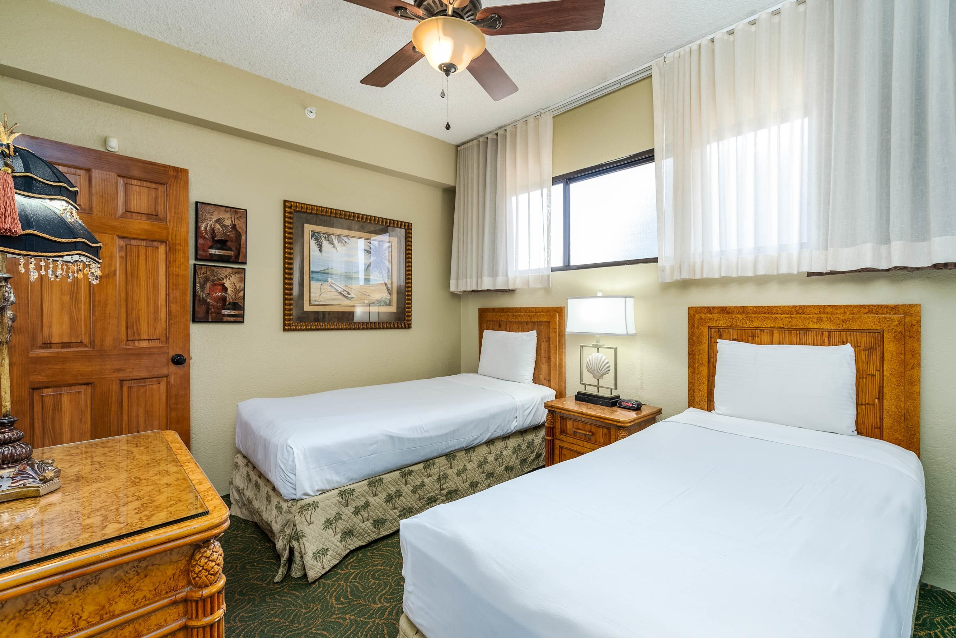 3445 Lower Honoapiilani Road, Unit 456 Lahaina, HI 96761 - Photo 17 of 32 a bedroom with two beds and a window