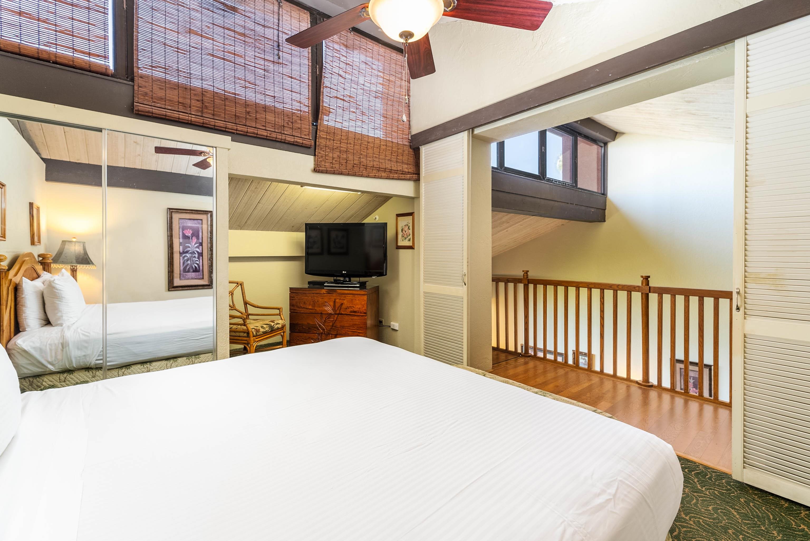 3445 Lower Honoapiilani Road, Unit 456 Lahaina, HI 96761 - Photo 25 of 32 a large bedroom with a bed and a large mirror on the dresser