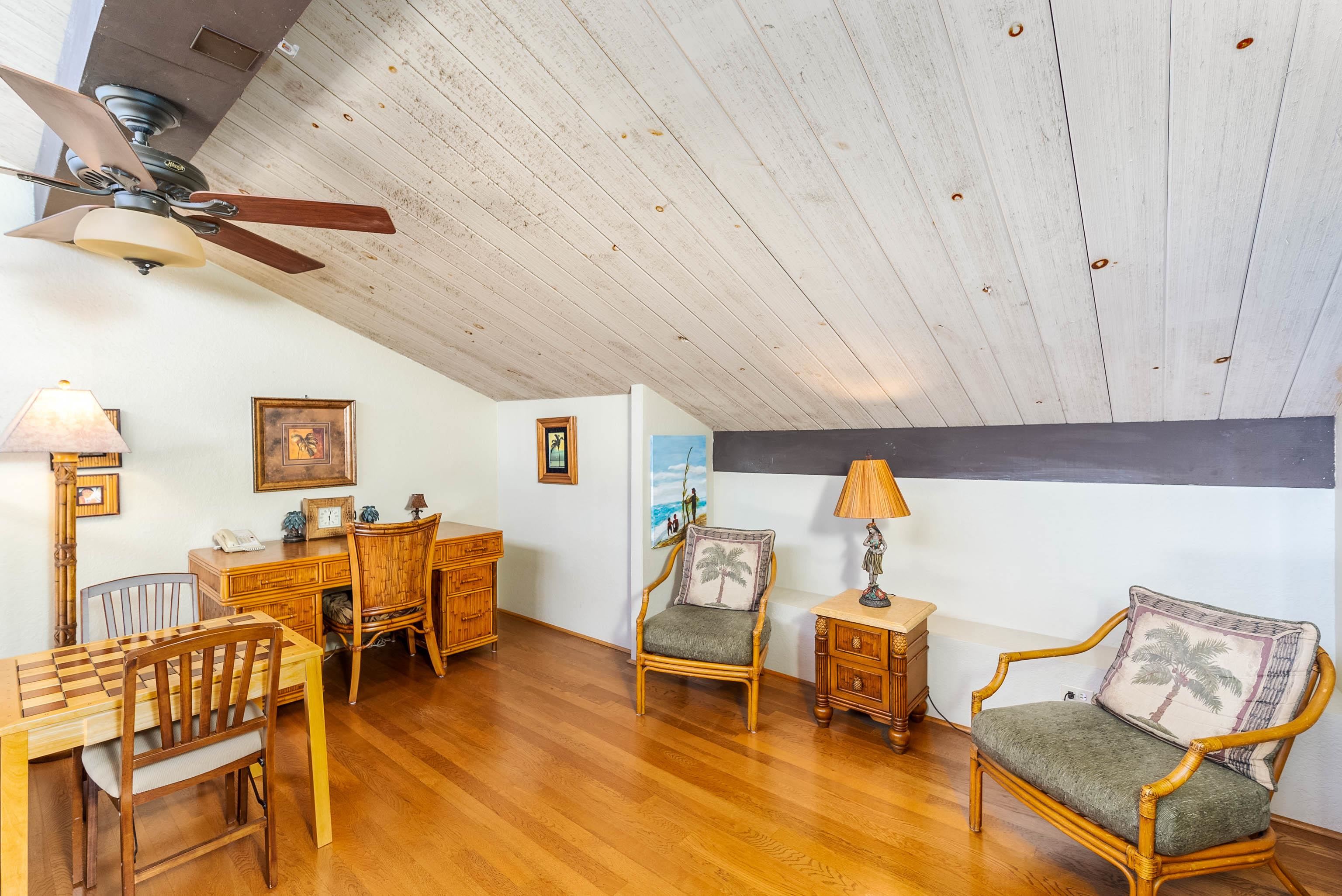 3445 Lower Honoapiilani Road, Unit 456 Lahaina, HI 96761 - Photo 26 of 32 a living room with furniture a dining table and chairs with wooden floor