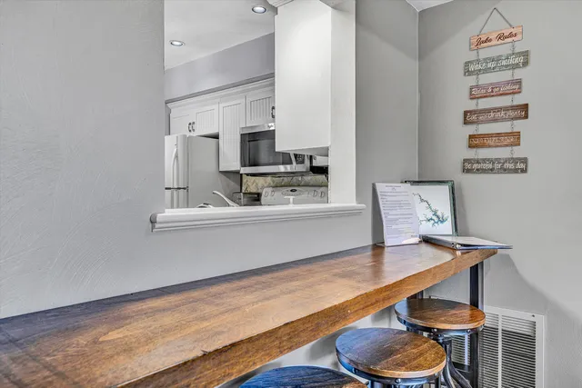 a kitchen with a sink cabinets and wooden floor