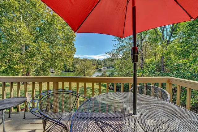 a view of a two chairs and table in the roof deck