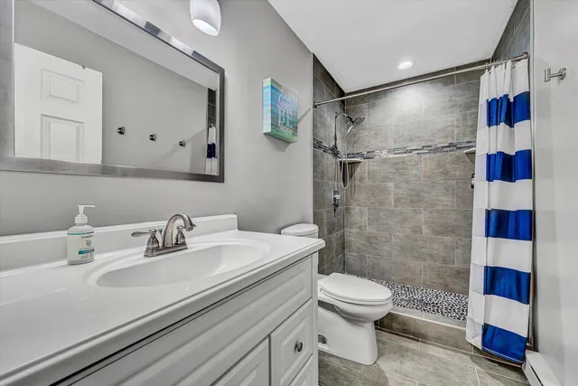 a bathroom with a sink toilet and shower