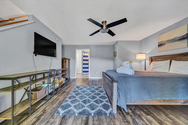 a bedroom with furniture and a flat screen tv